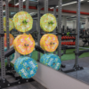 Colorful neon fleck bumper plates stacked for workout at a gym