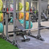 Colorful neon fleck bumper plates stacked for workout at a gym